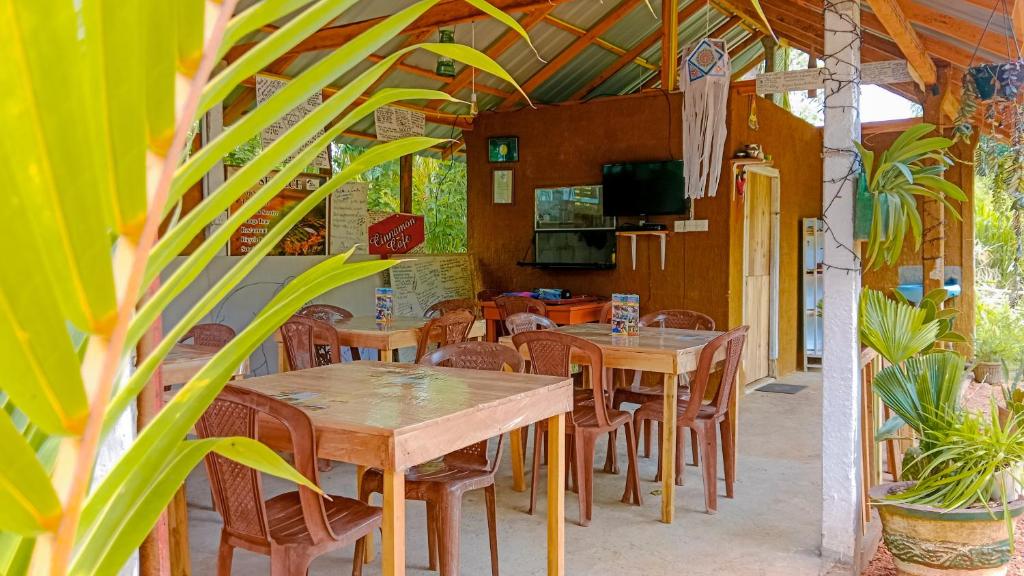 Sigiri Sky restaurant — open-sided dining room with wooden tables and chairs